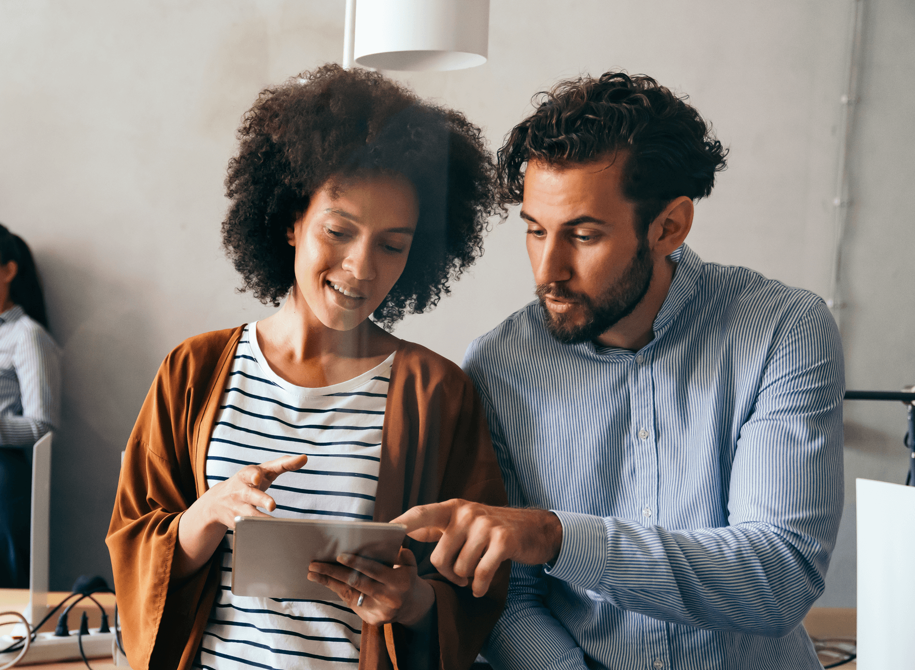 Two people looking at a tablet