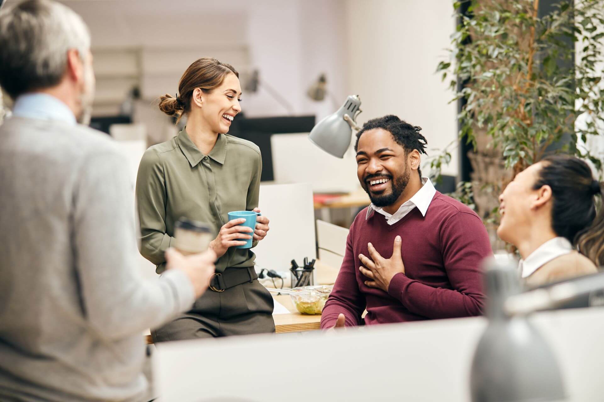 Co-workers laughing together in an office