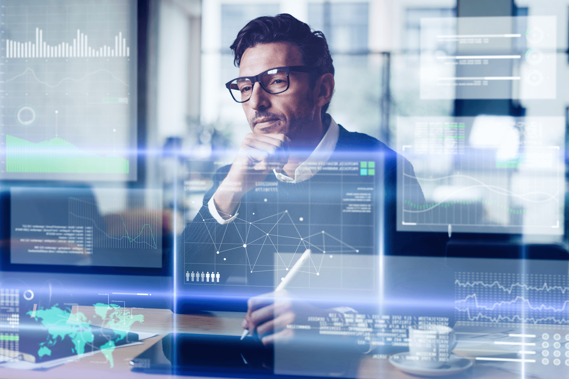 Man wearing glasses looking at a transparent screen where data is being displayed